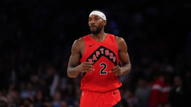 Kawhi Leonard wearing a red Toronto Raptors No. 2 jersey during an NBA game.