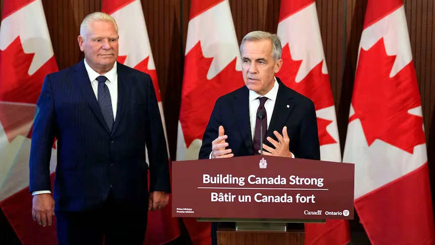 Prime Minister Mark Carney speaks at a news conference alongside Ontario Premier Doug Ford, with Canadian flags in the background.